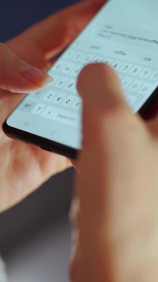 Female hands typing text on smartphone close up